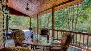 a screened in porch with a table and chairs at Come On Inn in Blue Ridge