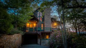 a house with lights on the front of it at Cabin Fever in Morganton