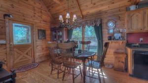 a dining room with a table and chairs in a cabin at Cabin Fever in Morganton