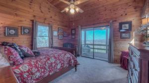 a bedroom with a bed in a log cabin at Cabin Fever in Morganton