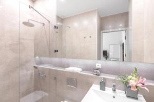 a bathroom with a shower and a sink and a mirror at Luxury Apartment 60 in Warsaw