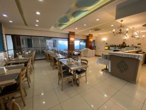 a dining room with tables and chairs in a restaurant at Grand Anzac Hotel in Çanakkale