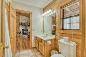a bathroom with a toilet sink and a fireplace at A Hen House by Venture Smoky Mountains in Pigeon Forge +64 photos