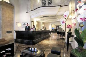 a lobby of a hotel with a bar and a man at Il Principe Hotel Catania in Catania