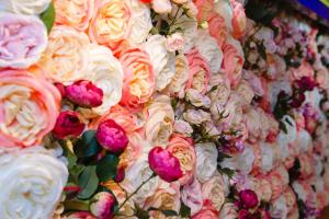 a wall of flowers with white and pink roses at The Griffin Belle Hotel Vauxhall in London