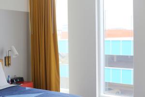 a bedroom with a bed and a sliding glass door at The Durham Hotel in Durham