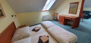 a bedroom with a large bed and a desk at Penzión Rodina in Levoča