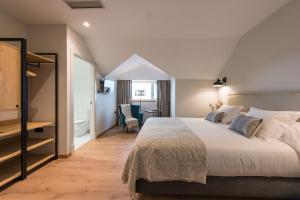 a bedroom with a large bed and a bathroom at Rías Altas - Hotel in Barreiros