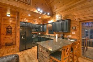 a kitchen with a large island in a cabin at Forever Joy in Blue Ridge