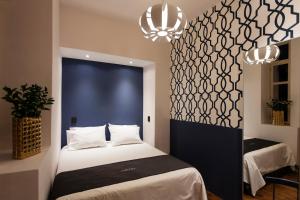 Voodi või voodid majutusasutuse Carlota Sustainable Design Hotel toas
