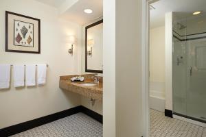 a bathroom with a sink and a shower at Inn at Pelican Bay in Naples