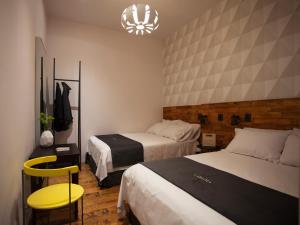 Voodi või voodid majutusasutuse Carlota Sustainable Design Hotel toas