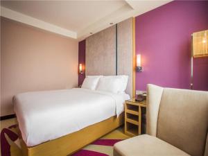 Voodi või voodid majutusasutuse Lavande Hotel Zhanjiang Guomao toas