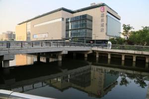 a building with a bridge over a body of water at Lavande hotel suzhou railway station store in Suzhou