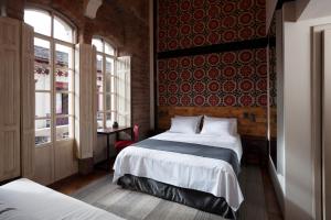 Voodi või voodid majutusasutuse Carlota Sustainable Design Hotel toas