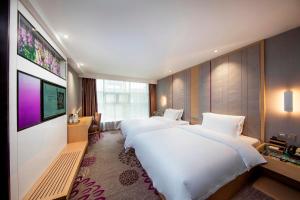 Un pat sau paturi într-o cameră la Lavande Hotels·Chengdu Hongpailou Metro Station +16 fotografii