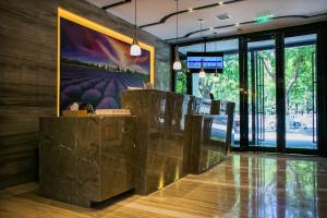 a restaurant with a large painting on the wall at Lavande Hotel Beijing Changping Government Street in Beijing