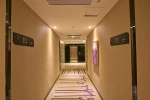 a hallway with a walkway with a painting on the wall at Lavande Hotel (Foshan Nanhai Square) in Foshan