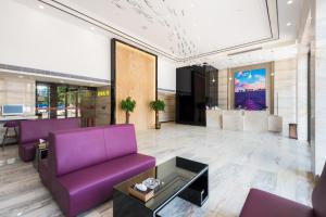 a lobby with purple chairs and a purple couch at Lavande Hotels·Guangzhou Dongpu Bus Terminal in Guangzhou