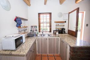 a kitchen with a sink and a microwave on a counter at Orchard Cottage in McGregor