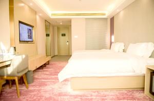 a bedroom with a large white bed and a desk at Lavande Hotel Beijing Changping Stadium in Beijing