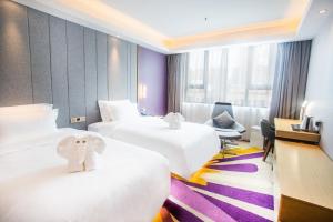 a hotel room with two beds with an elephant on them at Lavande Hotels·Shenzhen Baoan Xinan in Shenzhen