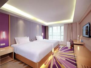 a hotel room with a large bed and a desk at Lavande Hotel Chengdu Chunxi Road in Chengdu