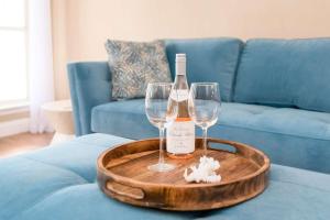 a bottle of wine and two wine glasses on a table at Beach Villa in Lago Vista +37 photos