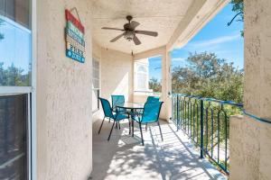 a patio with a table and chairs and a ceiling fan at Beach Villa in Lago Vista