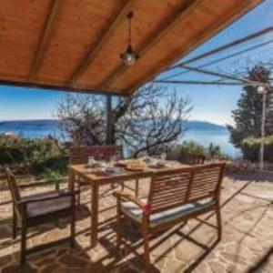 einen Tisch und Stühle auf einer Terrasse mit Meerblick in der Unterkunft Holiday Home Sea view in Brseč