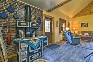 a living room with a brick wall and an old stove at Honey House Cabin - A Quiet Countryside Retreat! in Nappanee