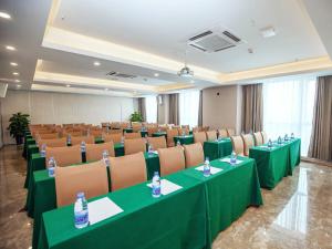 a conference room with green tables and chairs at Lavande Hotel Chongqing West Station Baguo Cheng in Chongqing