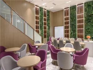 a waiting room with tables and purple chairs at Lavande Hotel Chengdou Qingbai River Phoenix Lake in Chengdu