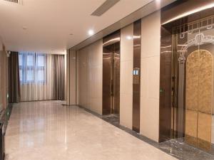 a hallway with elevators in a building at Lavande Hotels·Foshan Yanbu Suiyan East Road in Foshan