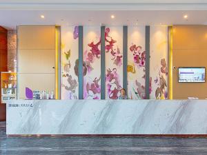 a lobby with a mural of flowers on the wall at Lavande Hotels·Foshan Yanbu Suiyan East Road in Foshan