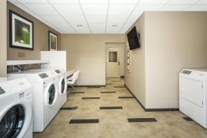 a kitchen with a white refrigerator and a white sink at Candlewood Suites Bensalem - Philadelphia Area, an IHG Hotel in Bensalem