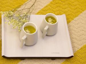 two cups of coffee sitting on a plate at Lavande Hotels·Nanjing South of Olympic Stadium Daishan New Town in Nanjing