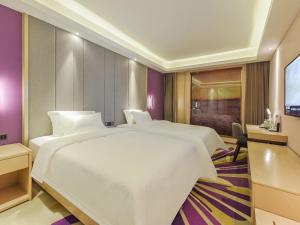a hotel room with two beds and a flat screen tv at Lavande Hotel Chongqing Nanping Pedestrian Street Convention and Exhibition Center in Chongqing +60 photos