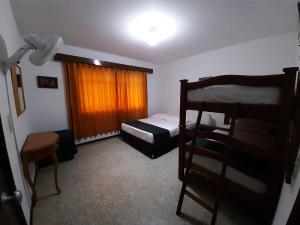 a bedroom with a bunk bed and a window at Finca Jerusalen in Tobia