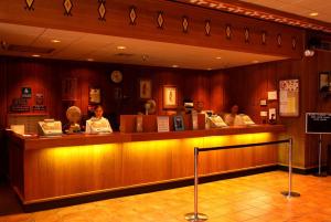two people sitting at a bar in a restaurant at Maswik Lodge - Inside the Park in Grand Canyon Village