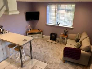 a living room with a couch and a table at The Annex, Manor Road, Didcot in Didcot