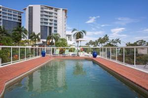 a swimming pool on the roof of a building at BreakFree Royal Harbour in Cairns