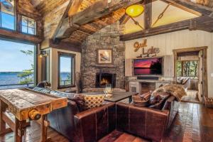ein Wohnzimmer mit einem Sofa und einem Steinkamin in der Unterkunft Gull Lakes Finest! Reclaimed Charm and Luxury in Lake Shore