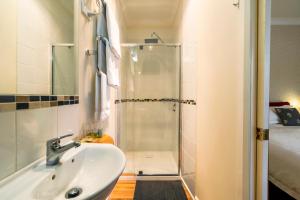 a bathroom with a sink and a shower at Ashdowns of Dover in Dover