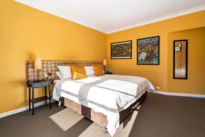 a bedroom with yellow walls and a large bed at Ashdowns of Dover in Dover