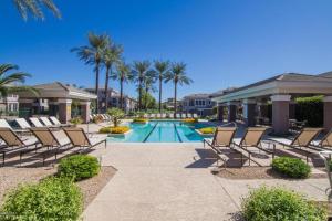 a swimming pool with lounge chairs and palm trees at *NEW* Lux Scottsdale Home with Pool, Hot Tub, and Gym in Scottsdale