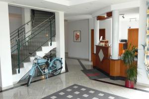 a bike parked in a hallway with a staircase at Hotel Bachwiesen in Langensendelbach