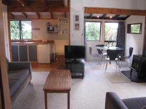 a living room with a couch and a table at Miro Magic - Ohakune Holiday Home in Ohakune