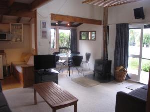 a living room with a couch and a table at Miro Magic - Ohakune Holiday Home in Ohakune