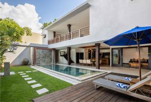 an image of a house with a swimming pool and an umbrella at Danoya Private Luxury Residences in Seminyak
